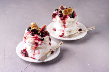 Mini Pavlova Cake with Figs and Berry Tasty Dessert Pavlova on White Plate Gray Background Horizontal Copy Space