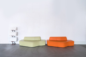 Orange and green sofa in empty room