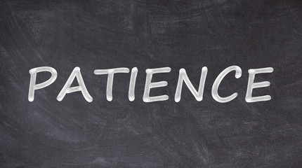 Patience text written on blackboard