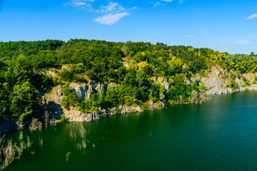 Naklejka na ściany i meble Beautiful lake in the abandoned granite quarry on summer