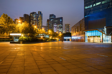 At night, modern city buildings and plazas are in the financial center of Qingdao, China.