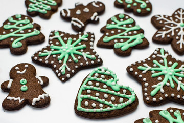 Gingerbread cookies on white background. Snowflake, star, man, heart shapes.