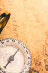 Close up vintage compass on global map