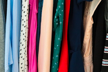several colored garments in a wardrobe