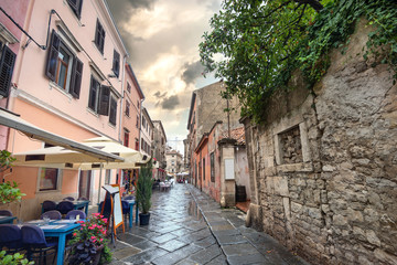 Fototapeta na wymiar Narrow street in historic center in Pula. Istria, Croatia