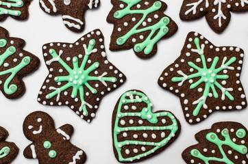 Gingerbread cookies on white background. Snowflake, star, man, heart shapes.