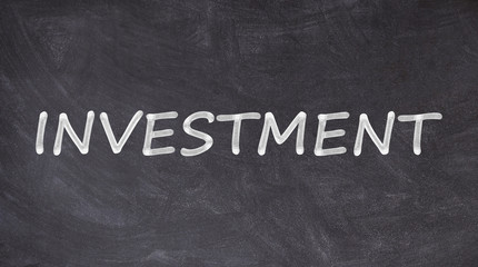Fototapeta premium Investment text written on blackboard