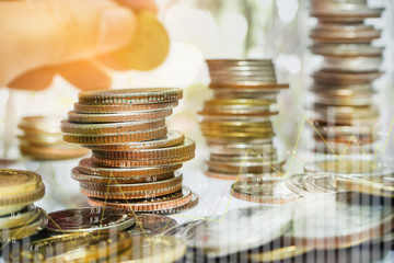 Graphs and rows of coins to communicate finance, investment, money collection and money management that have grown and have business value.