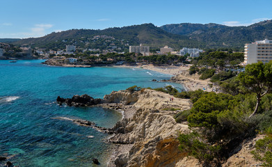 Fototapeta na wymiar Waterside view turquoise sea rocky coastline of Paguera beach, Palma de Mallorca, Spain