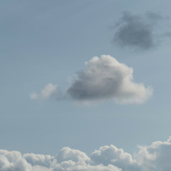 Behind cloud seven a dark cloud begins softly to rise in heaven. Cloud formation as symbol for problems to start. 