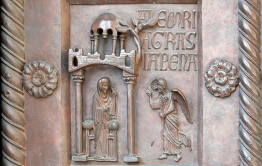 Annunciation of the Virgin Mary on the San Ranieri gate of the Cathedral St. Mary of the Assumption in Pisa, Italy 
