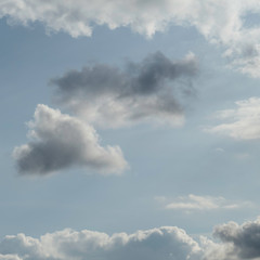 One fluffy cloud staying strong in a cloudy sky.