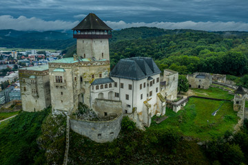 Aerial panorama view of medieval newly restored Trencin castle over the Vah river in Slovakia  with dramatic sky