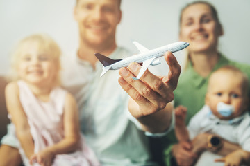 travel with kids - young happy family planning next journey by plane