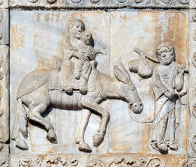 Fototapeta na wymiar Flight to Egypt, medieval relief on the facade of Basilica of San Zeno in Verona, Italy