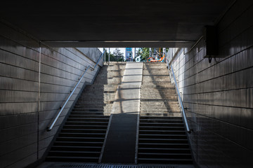 Empty underground pedestrian crossing. The tunnel and the day light at the end of it. Steps to the...