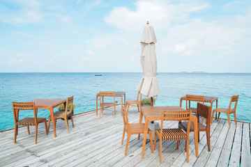 Outdoor terrace with Empty  wooden table and chair with Sea view of Indain ocean, Maldives background