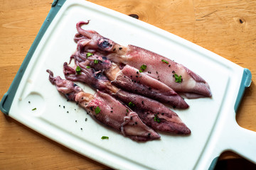 Calamari on kitchen board.