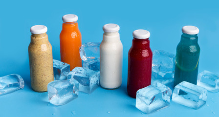 Healthy and useful colorful detox cocktails with ice on blue