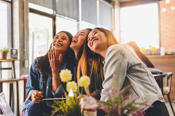 Portrait of cheerful young friends in Cafe Multiracial happy young people laughing enjoying meal having fun sitting together.pleasant conversation during coffee break.