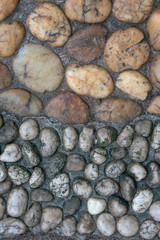 Half frame have big brown stone and small white stone on another half.