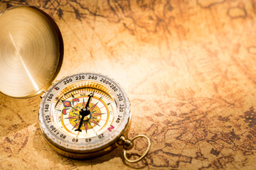 Fototapeta na wymiar Vintage compass on global map close up.