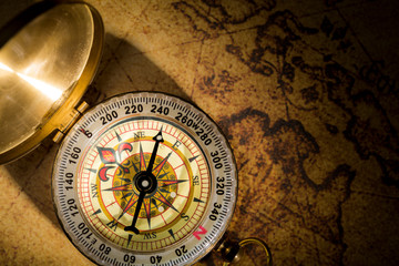 Fototapeta na wymiar top view vintage compass on wolrd map