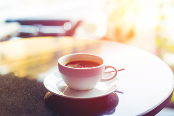 Obraz na płótnie Canvas Hot coffee on cafe table. vintage filter