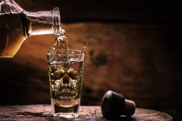 Poster Drink bottle and glass with alcohol content. Image of translucent skull in glass. Alcoholism, addiction or poison concept. © RHJ