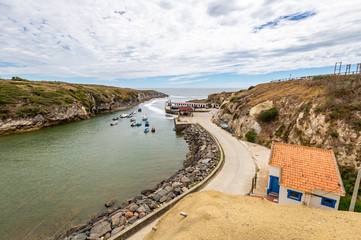 Little fishing village of Porto Covo, Alentejo, Portugal. Views to the harbor and boats.