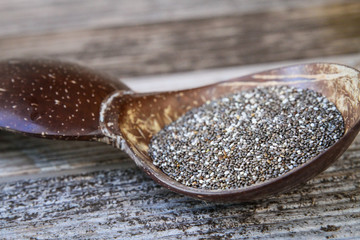 Chia Seeds in Spoon on Wood Table (Close-up)