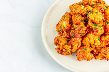 Buffalo Cauliflower Bites on White Background Directly Above Photo.