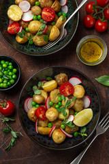 baby potatoes salad with tomato, green peas and radish