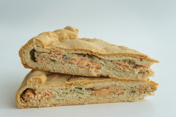 piece of cake with fish filling on a white background.