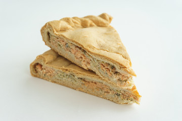 piece of cake with fish filling on a white background.