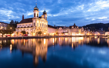 Fototapeta na wymiar Jesuitenkirche or Jesuit Church next to Reuss rivet in Lucerne, Switzerland, cityscape during twilight