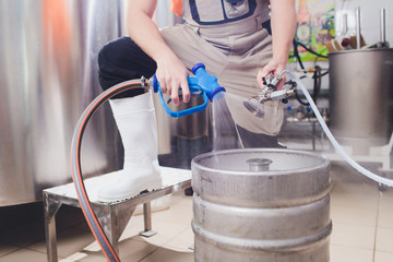Craft beer brewing equipment in brewery Metal tanks, alcoholic drink production.