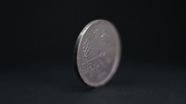 Close Up Of 1 Deutsche Mark Coin Rotating On Black Background.