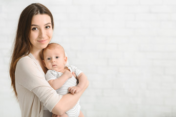 Portrait of loving mother with her adorable newborn baby