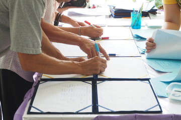 Group of people signing their names to attend a seminar program and training course. Event participation and attendant registration concept
