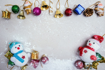Happy Christmas composition. Gifts, Bell,Ball on top,Snowman and snow on white background. Christmas, winter, Christmas holiday concept. top view, copy space.