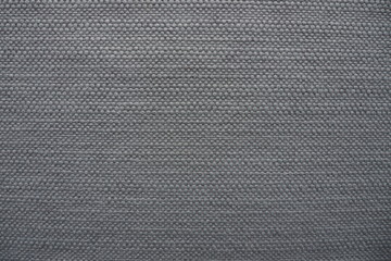 Fototapeta na wymiar Closeup of beautiful woven fabric with texture in dark grey tone for luxury background and decoration. Cool banner on page, ad, website, presentation. Monochrome seamless modern pattern