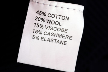 White label on clothing indicating the percentage of material content in the fabric. The...
