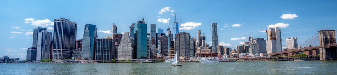 Fototapeta na wymiar New York city skyline with a passing sail boat