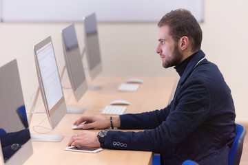 Fototapeta premium Programming. Man Working On Computer In IT Office, Sitting At Desk Writing Codes. Programmer Typing Data Code, Working On Project In Software Development Company. High Quality Image.
