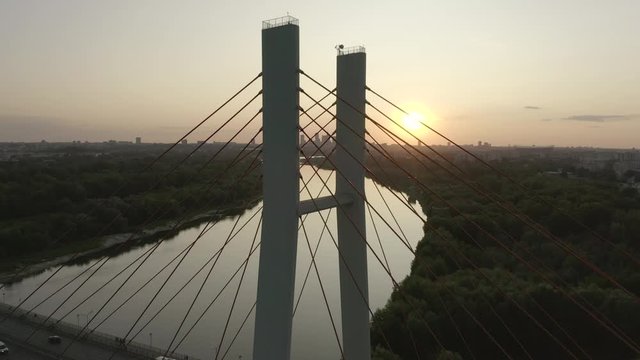 Aerial view of the city in Warsaw, Poland. A drone flew over the bridge at sunset.  Evening aerial view of the bridge Siekierkowski  and cityscape. Drone Shot 4K.