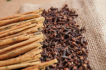 cloves with cinnamon lined up neatly on the gunny sack