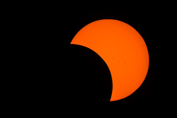 Partial solar eclipse. Sunspots are present. Turbulence can be seen on the surface of the sun (this...