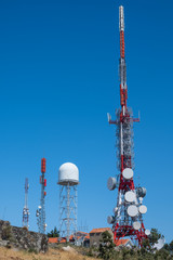 Group of antennas, satellite dishes for telecommunications, television broadcast, cellphone, radio and satellite. Electromagnetic and environmental pollution