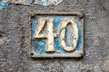 Number 40, forty, street number sign on the wall